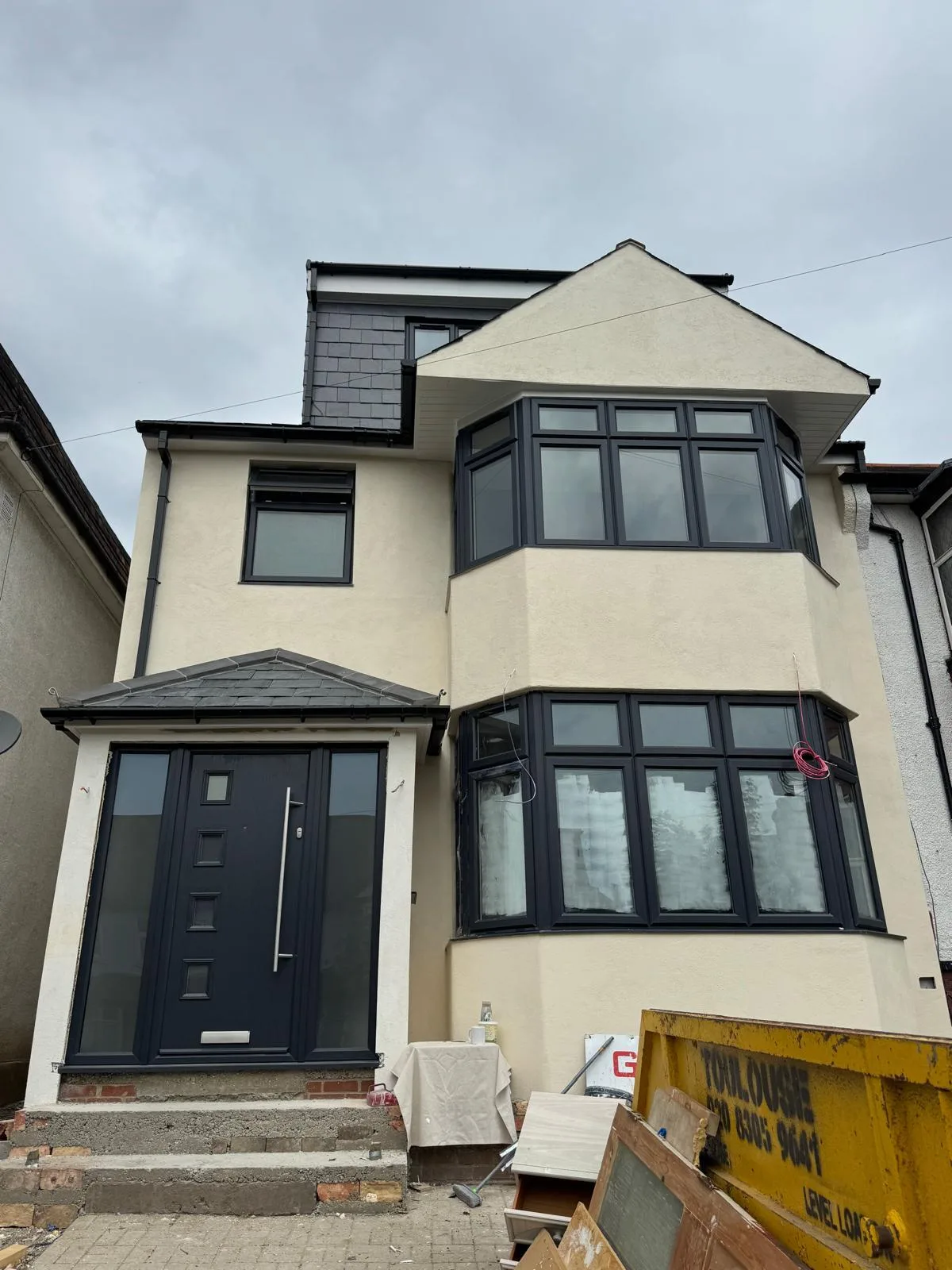 Anthracite bays on a cream rendered house