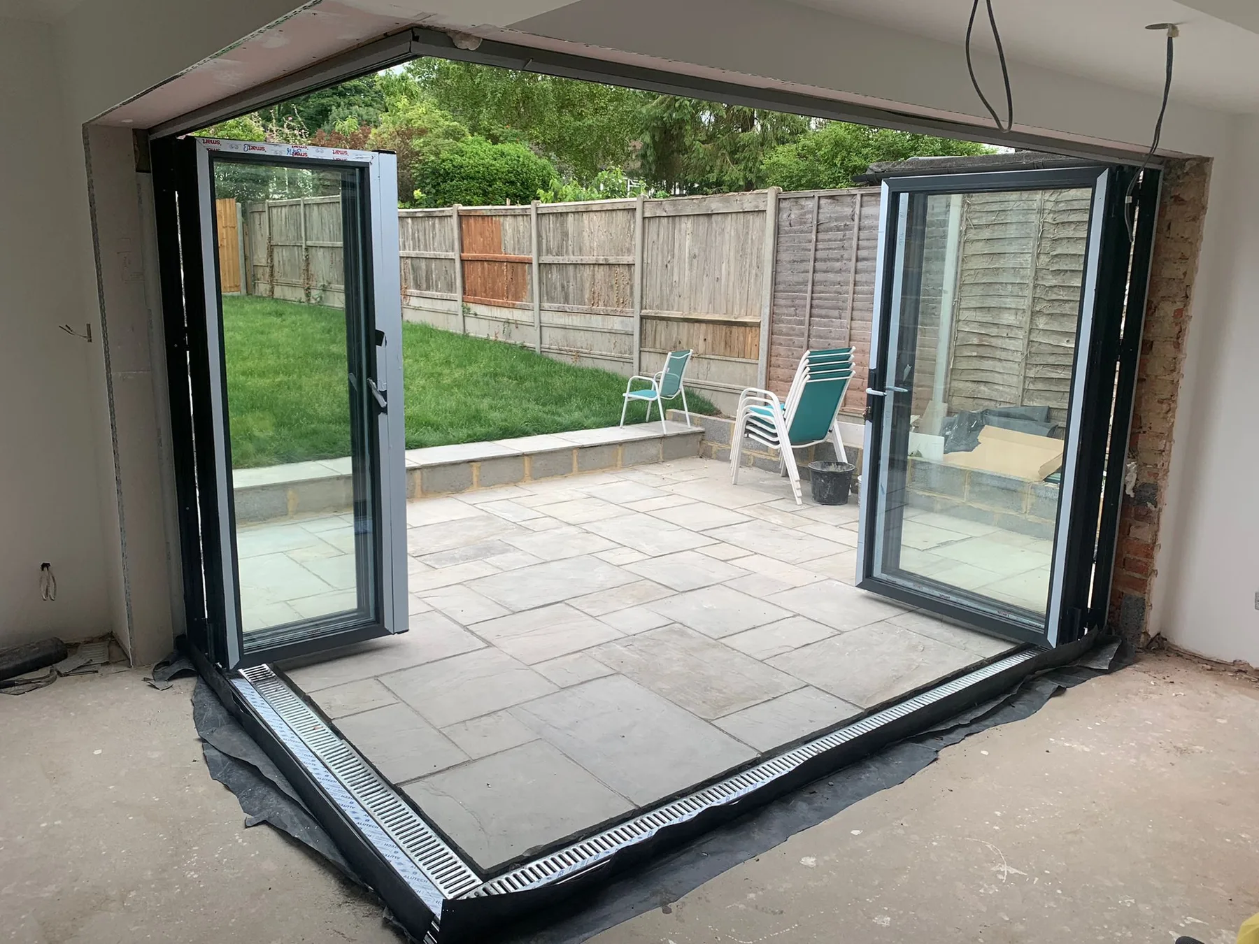 Bi-folds part-open onto a paved terrace