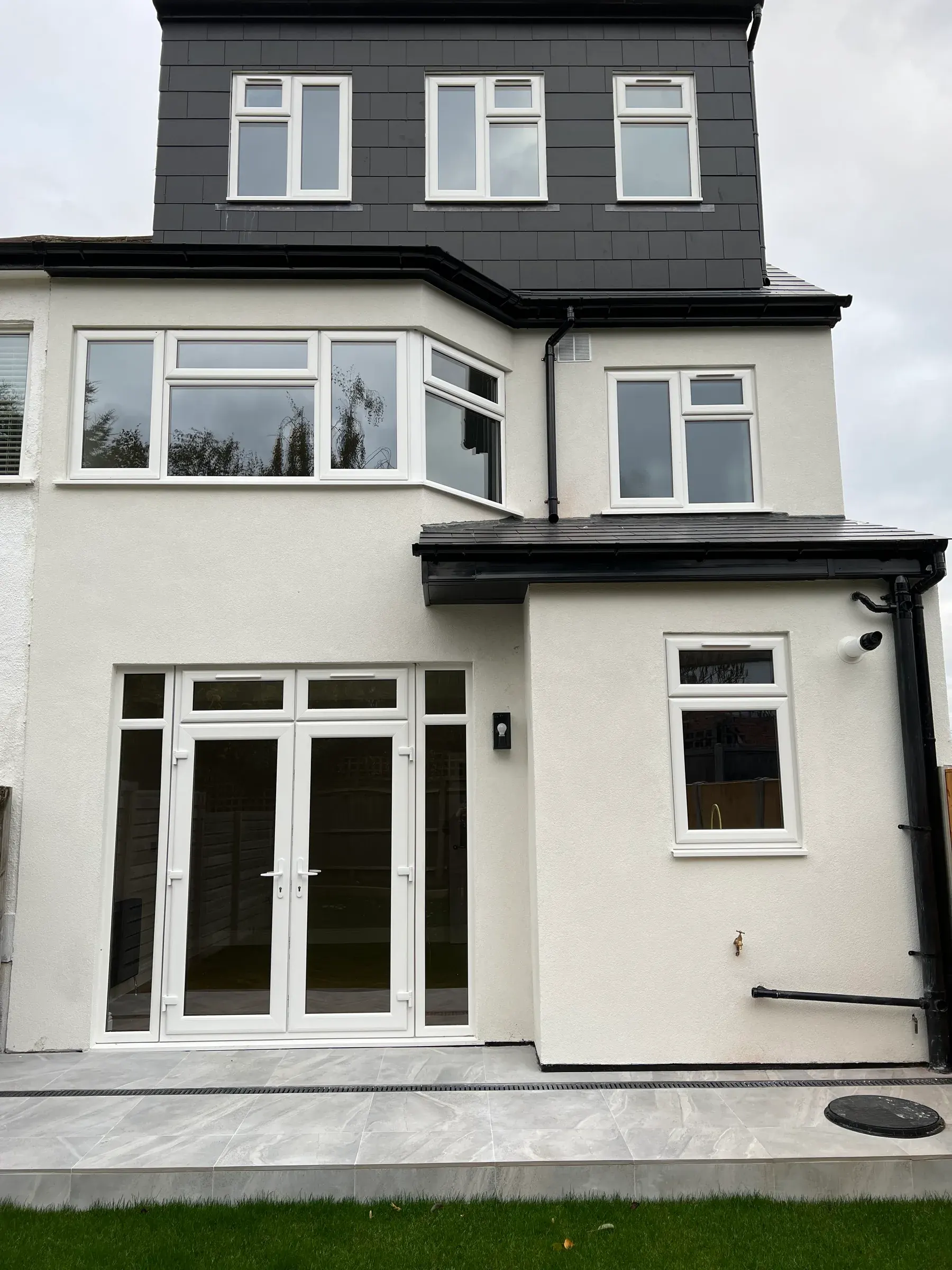 White casements and French doors, rendered extension