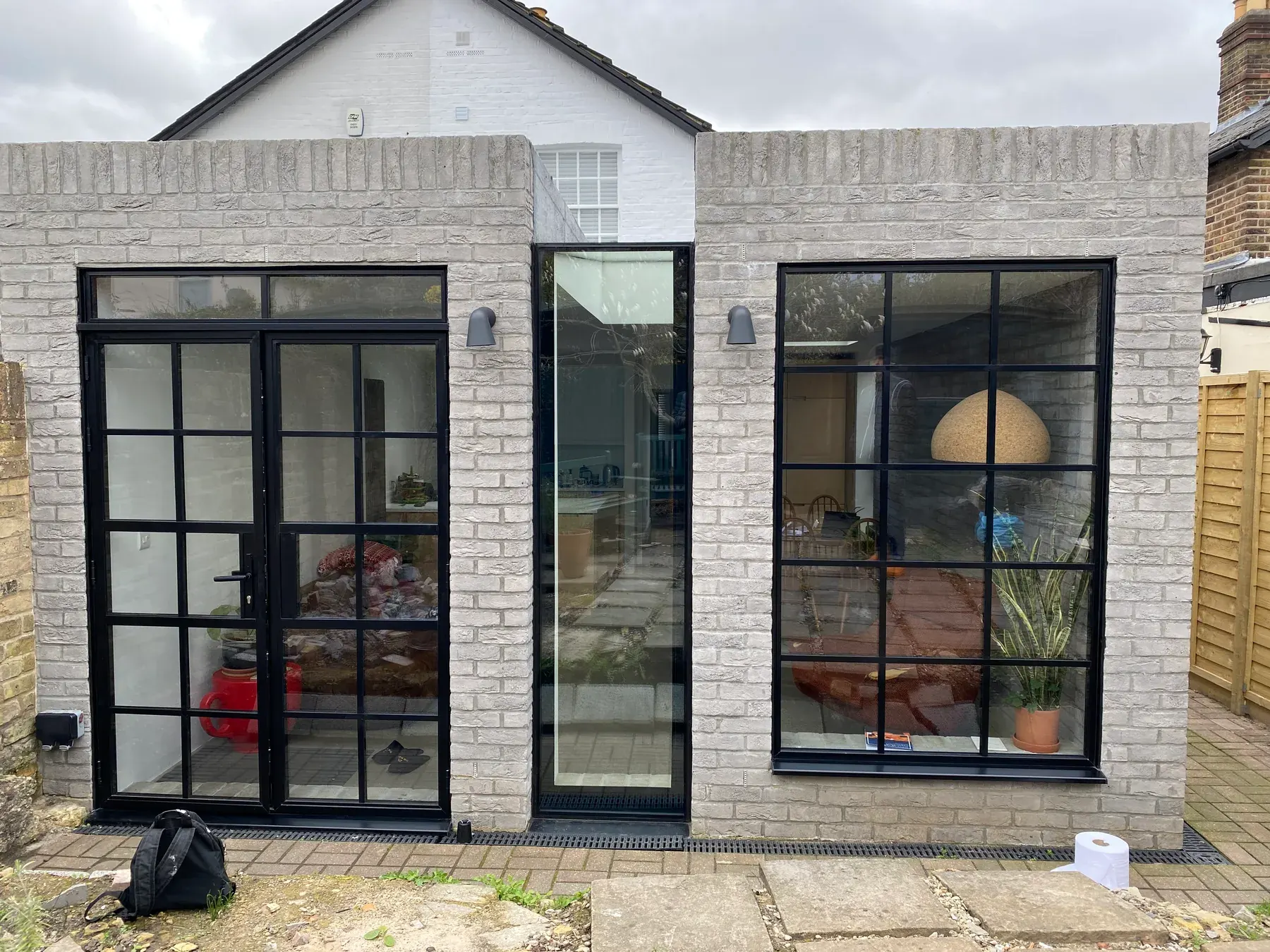Crittall-style door and window, painted brick elevation