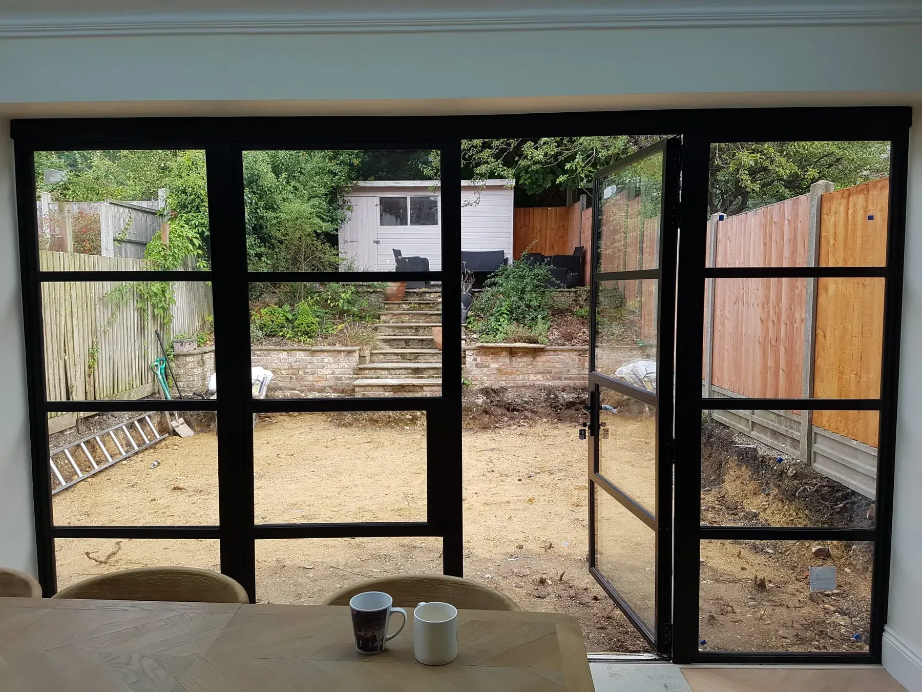 Full-width Crittall screen onto the garden