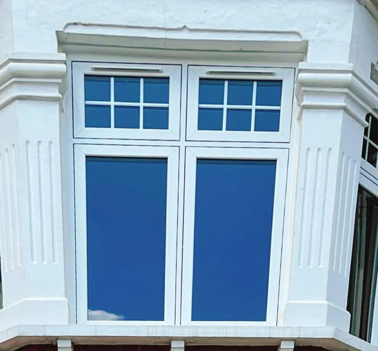 Flush casement in an ornate stucco surround