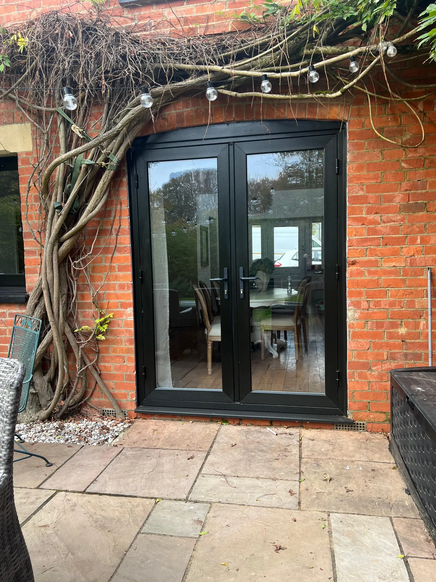 Anthracite French doors onto a brick patio