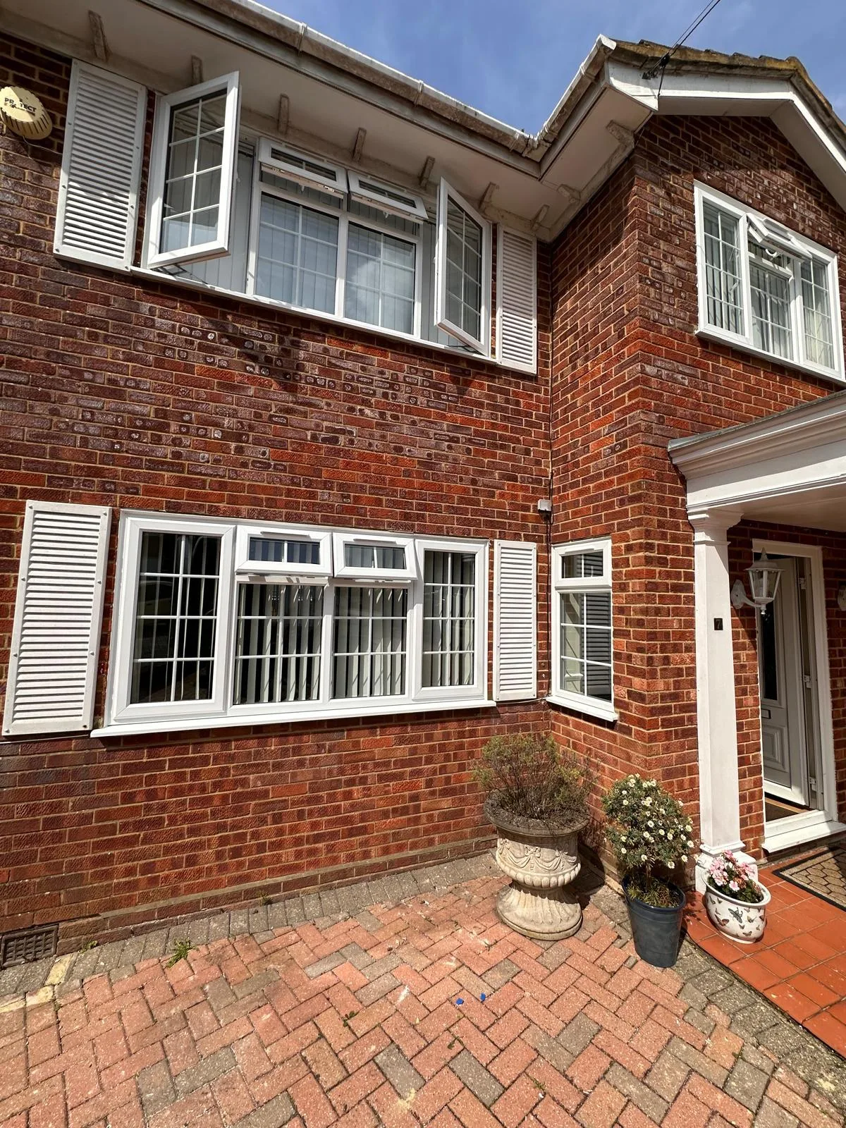 Heritage windows with shutters, red brick