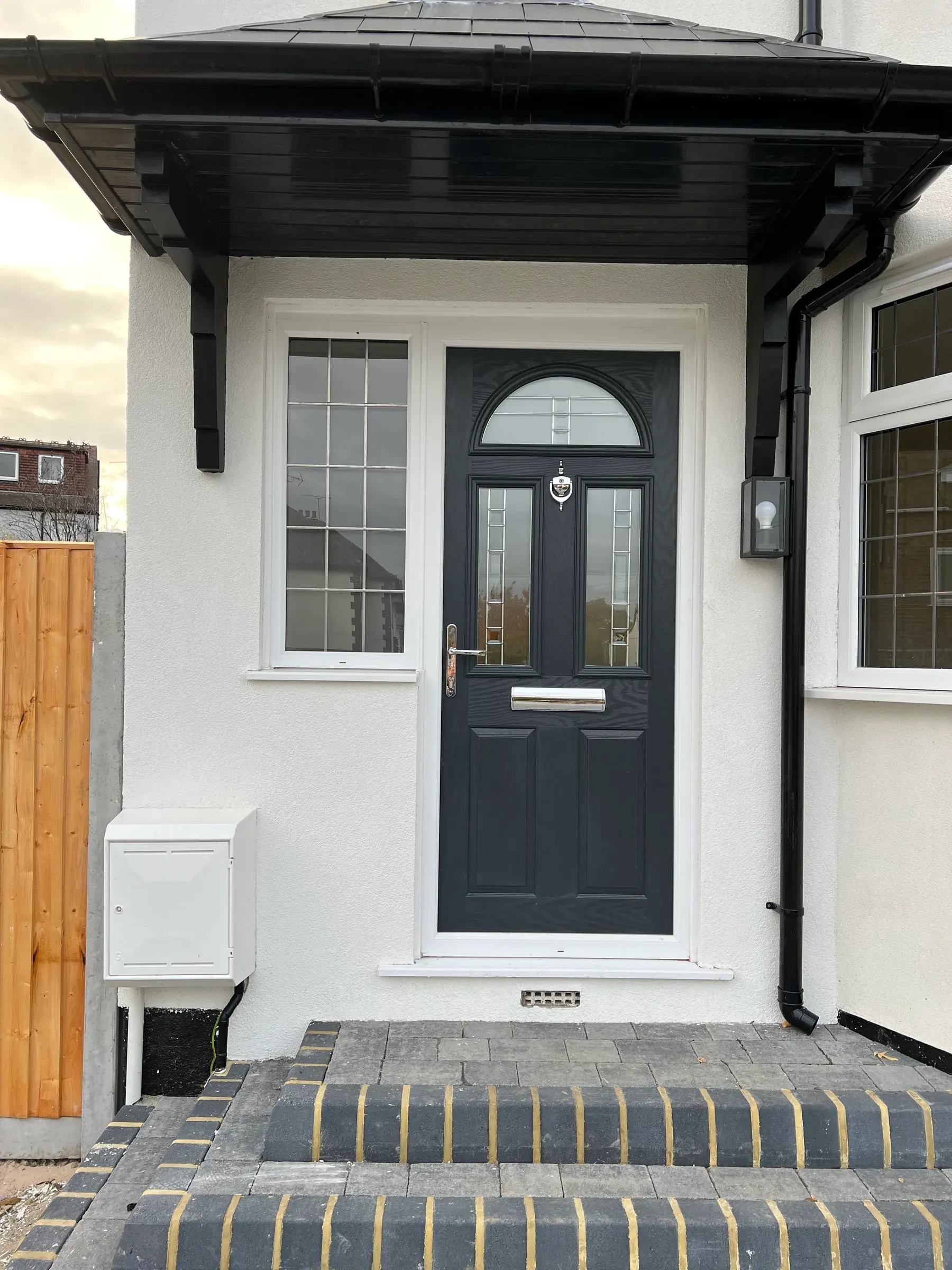 Navy composite front door with arched fanlight