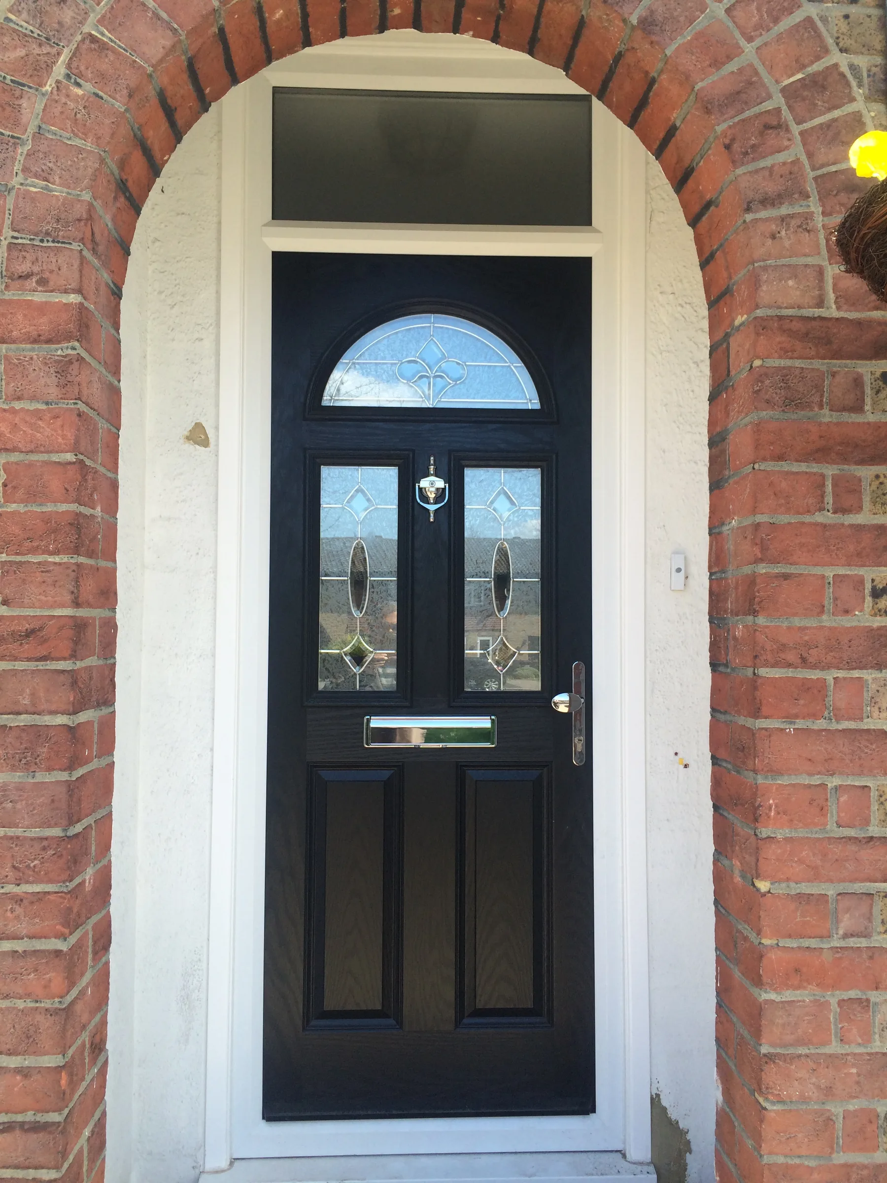 Grey composite door in a brick arch