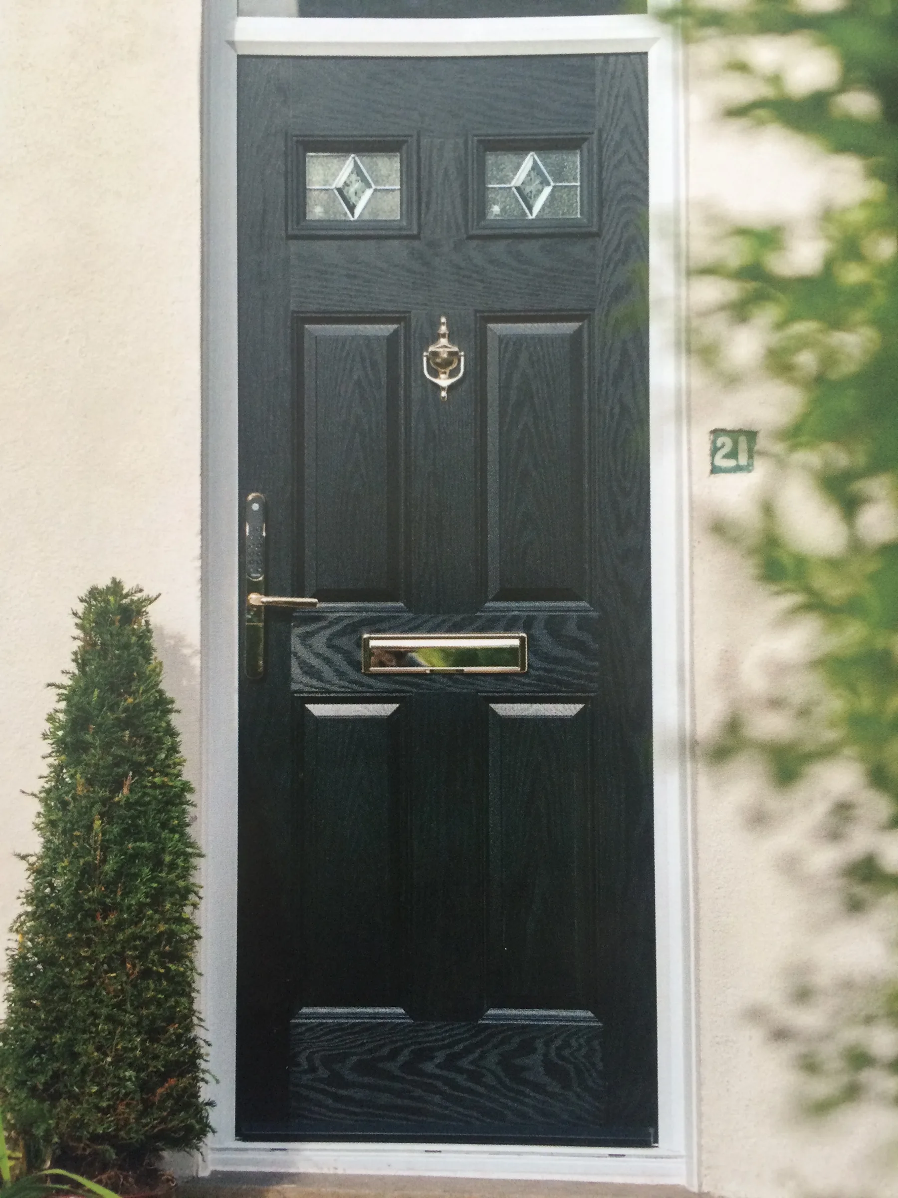 Black composite front door, clipped topiary