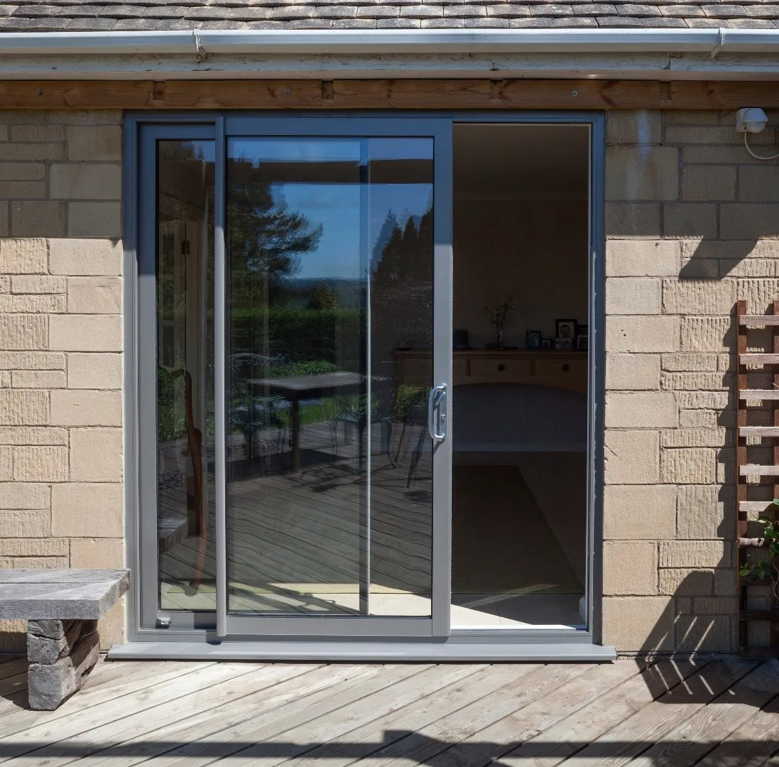 Sliding doors onto a timber deck, stone elevation